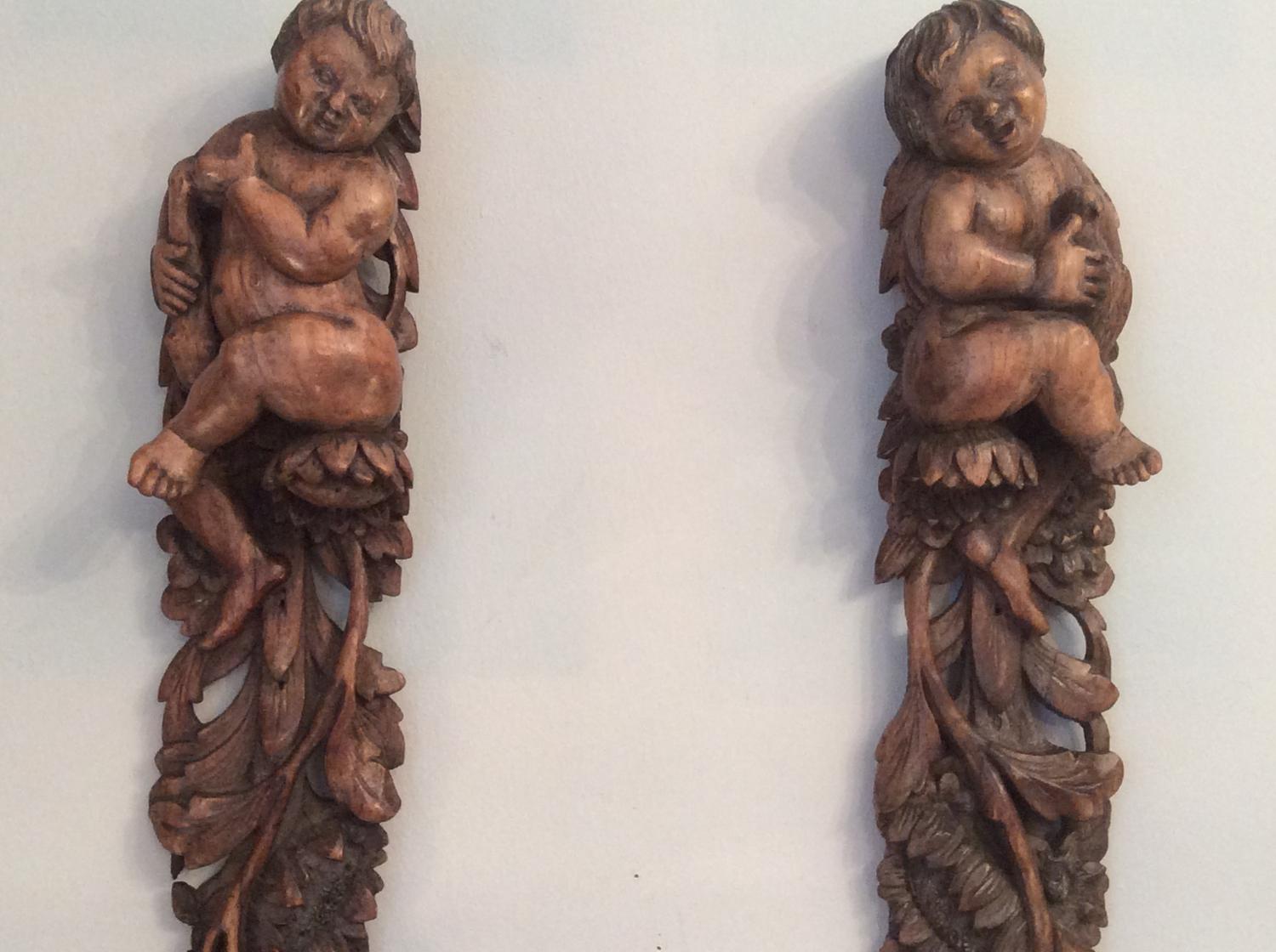 Pair of walnut 17th century putti carvings